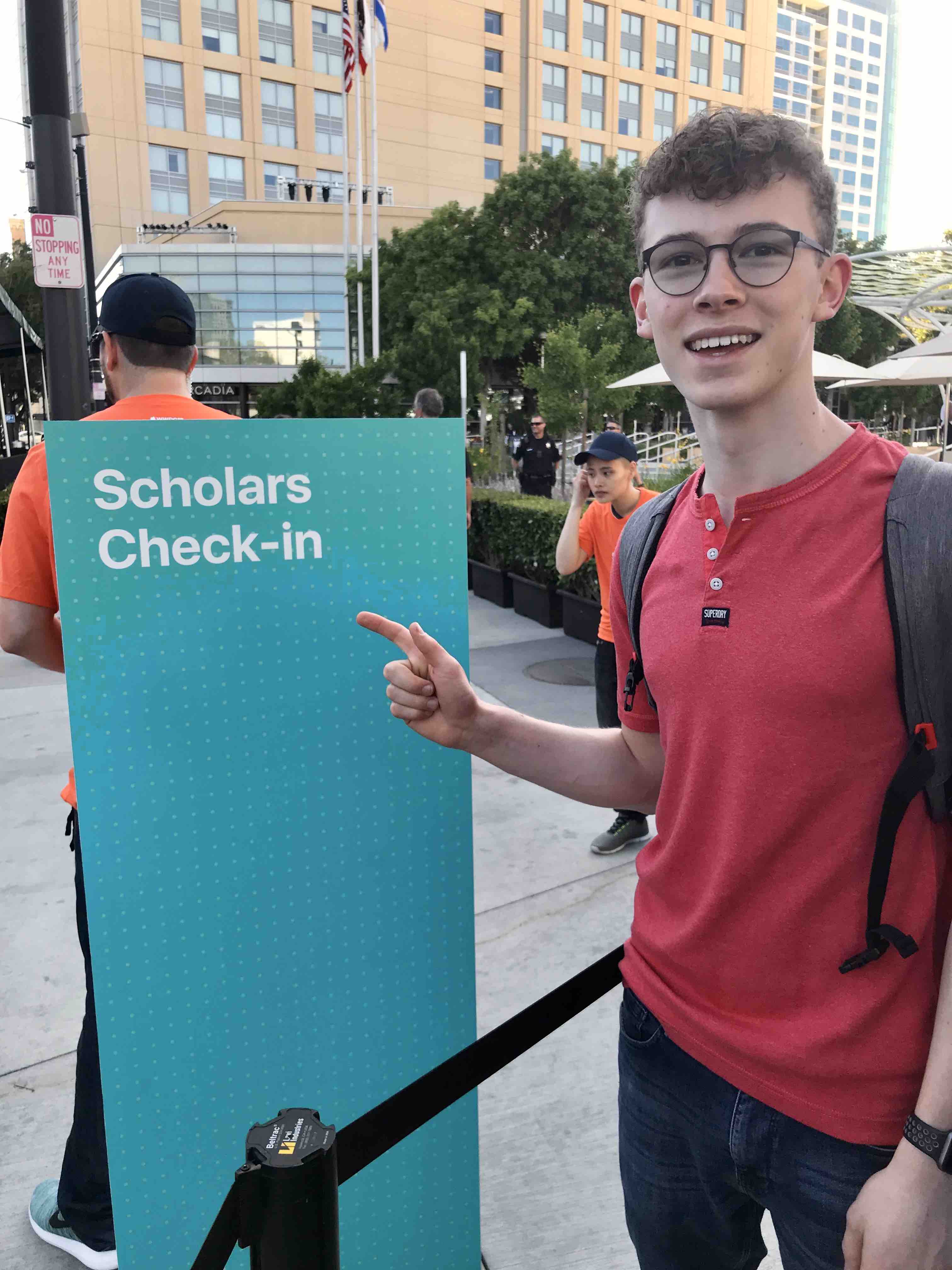 Me in front of the sign for WWDC 2018 Student Scholarship registration